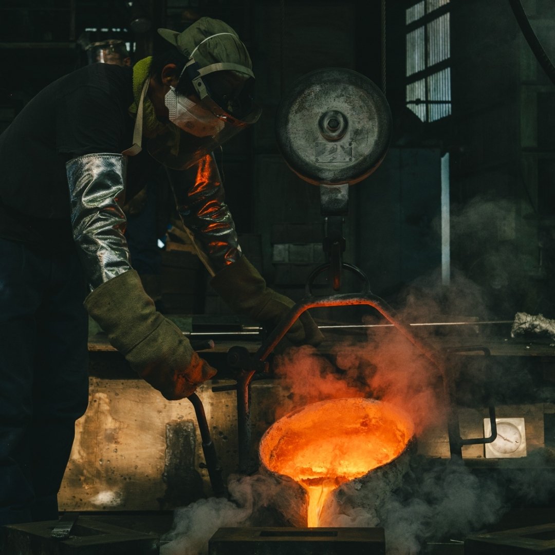 Craftsman pouring molten metal in Kanamori Alloy foundry making kenzan and Japanese flower vases