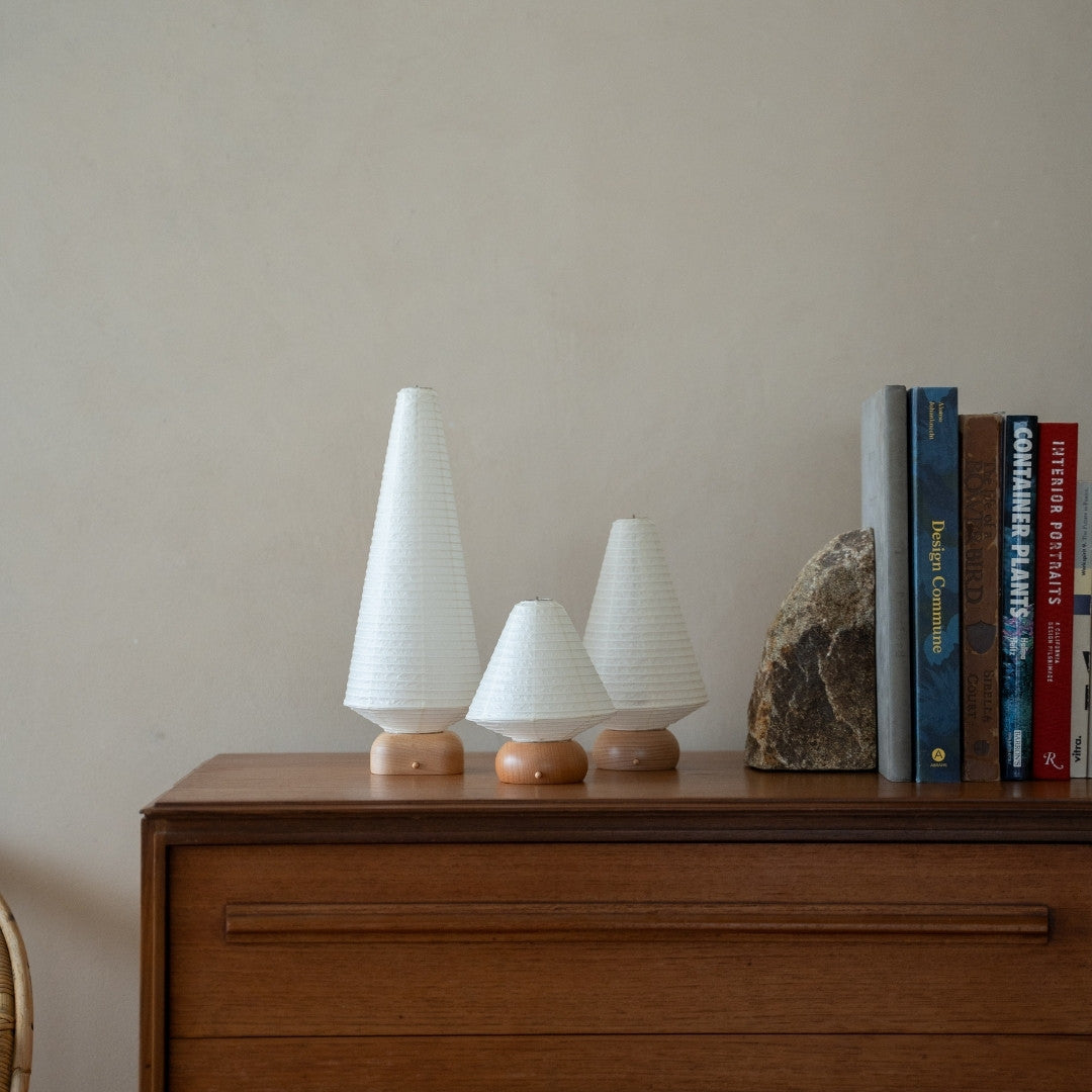 Three Japanese Paper Table Lamps on wooden shelf in Japandi style living room – Unique portable paper lamps for bedside tables