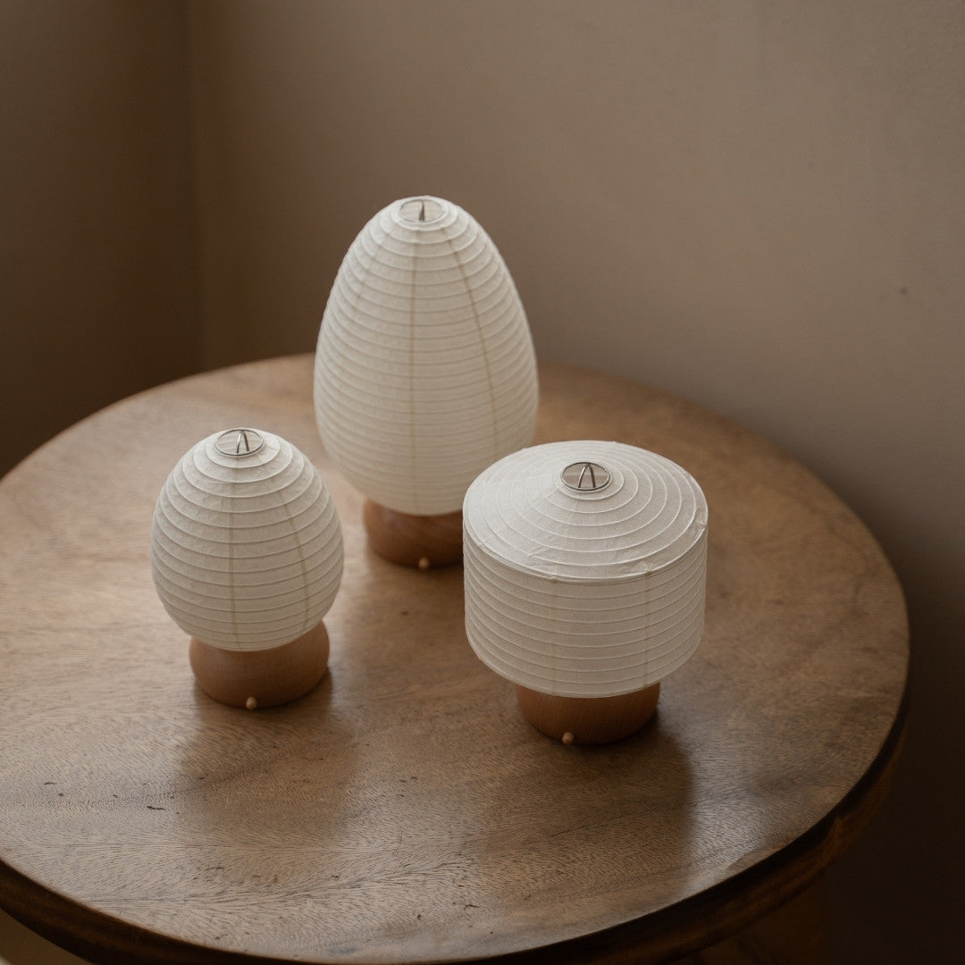 Three Japanese Paper Table Lamps on wooden table in Japandi style living room – Wabi-Sabi Portable paper lamps for Japandi interior
