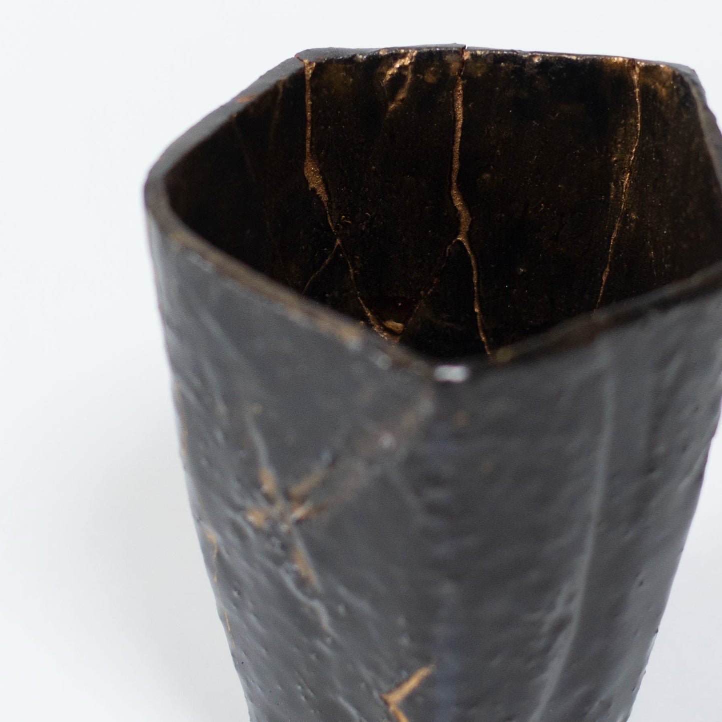 Top view of Pentagon Kintsugi Cup "Tenmoku" Black 02, showcasing its unique pentagonal shape