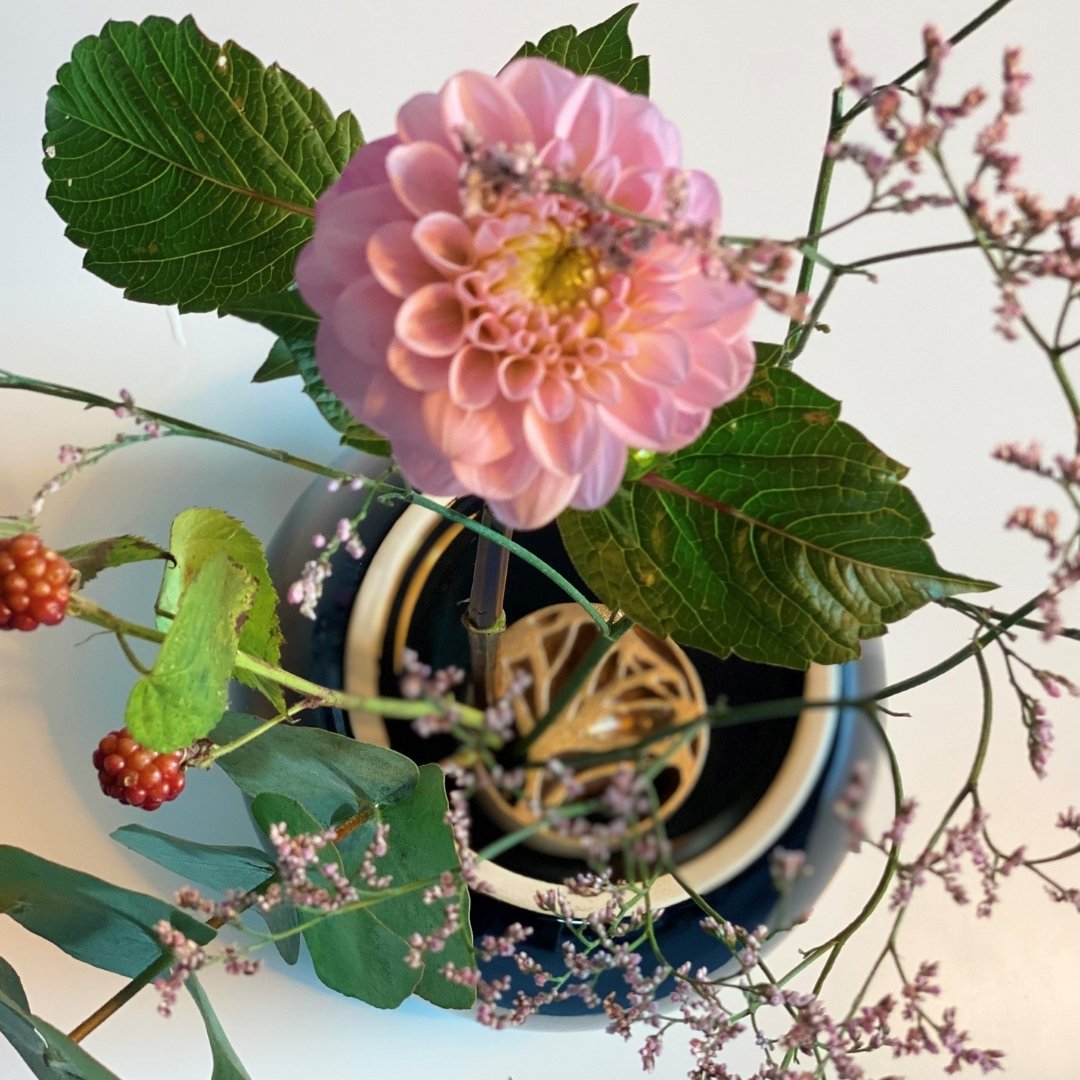 Top view of ikebana flower arrangement in Japanese vase with pinless kenzan the ginkgo