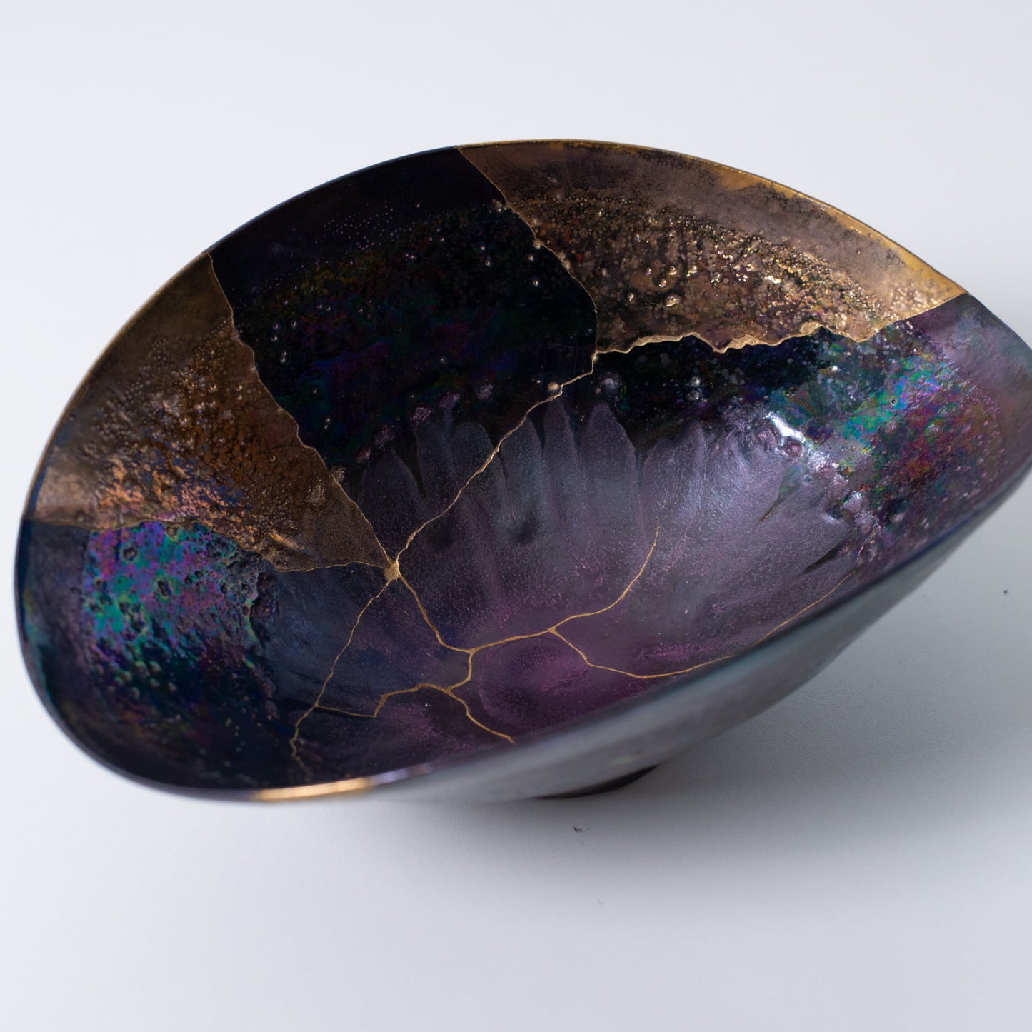 Top view of Kintsugi bowl with urushi lacquer and gold lines expressing renewal