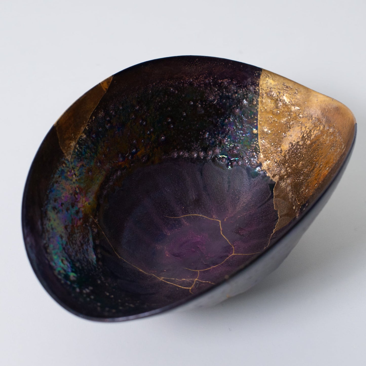 Top view of Kintsugi bowl with urushi lacquer and gold lines expressing renewal