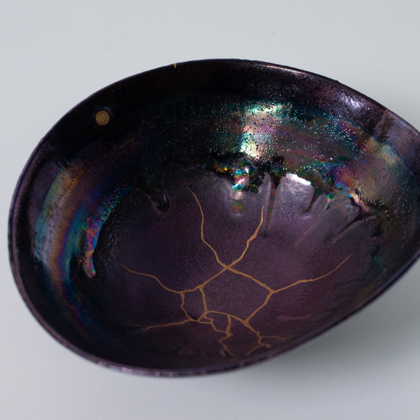 Top view of Japanese Kintsugi bowl revealing wabi-sabi patterns in gold and lacquer