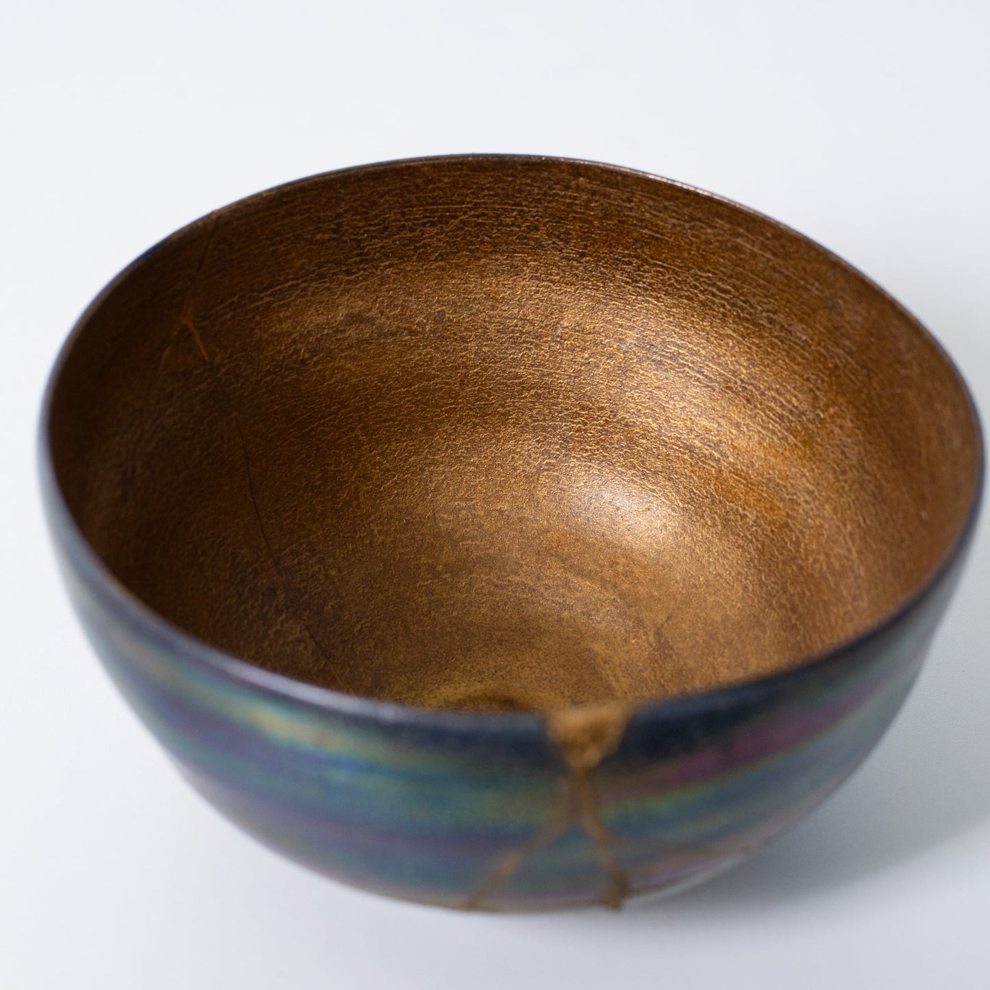 Top view of handcrafted Kintsugi bowl revealing golden seams and wabi-sabi beauty