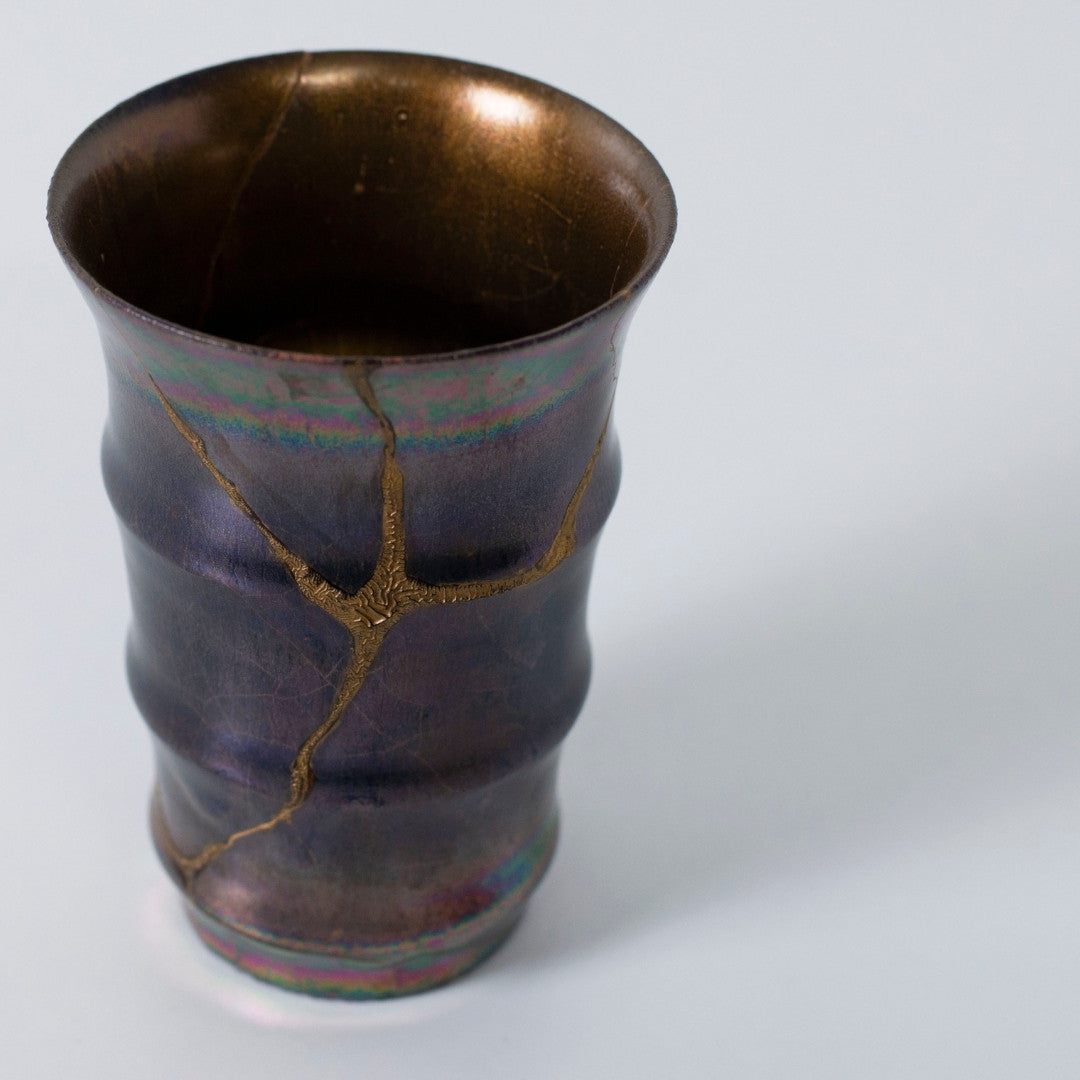 Top view of Magenta Luster kintsugi pottery with gold repair lines | wabi sabi art style