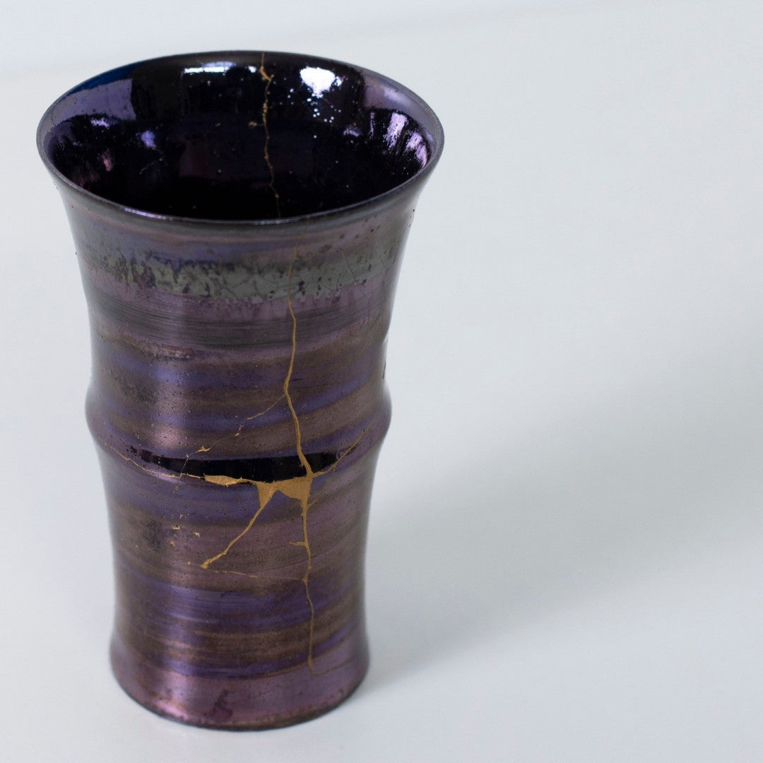 Top view of glossy purple kintsugi cup with dramatic golden crack | wabi sabi pottery