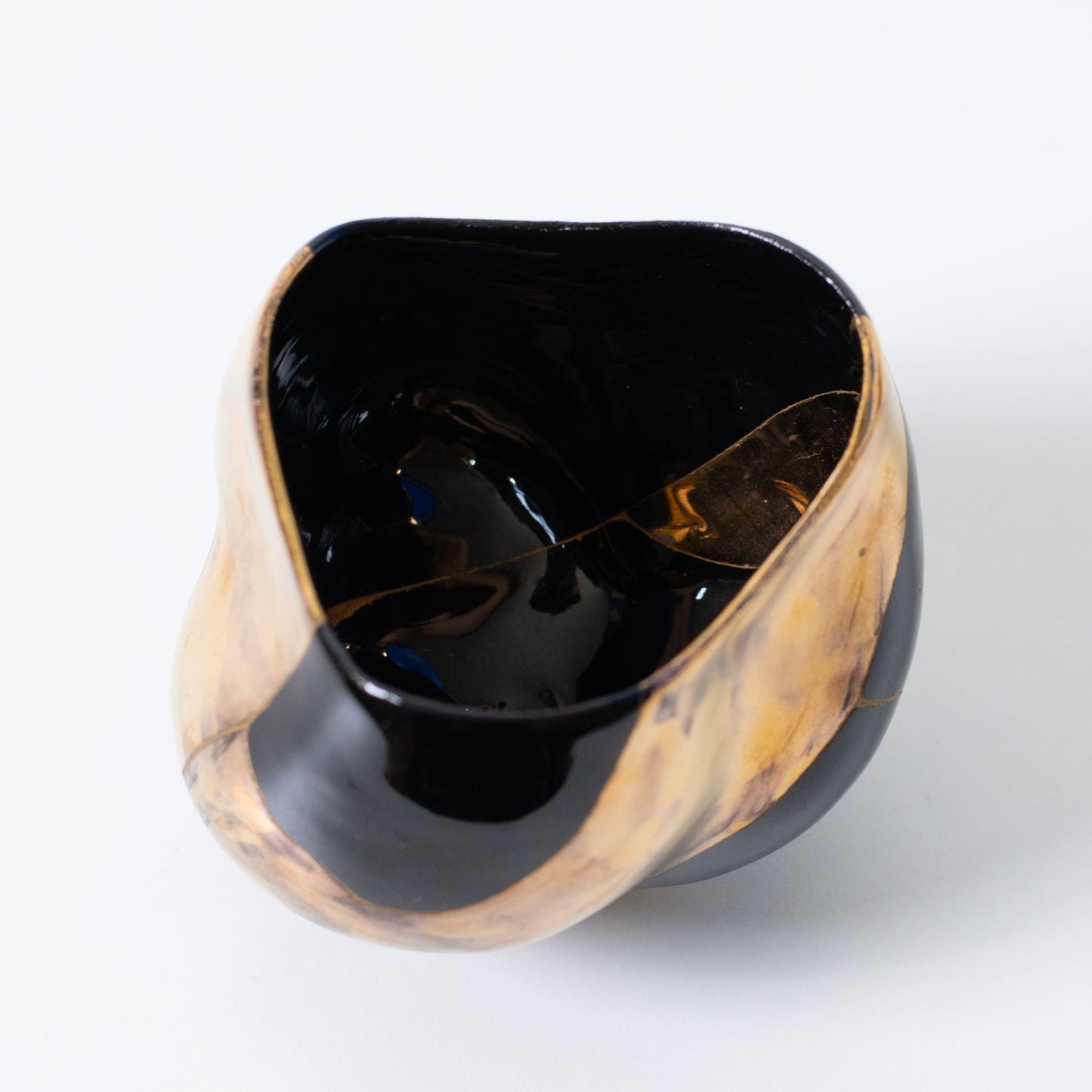 Top view of Japanese kintsugi matcha bowl representing wabi-sabi and resilience