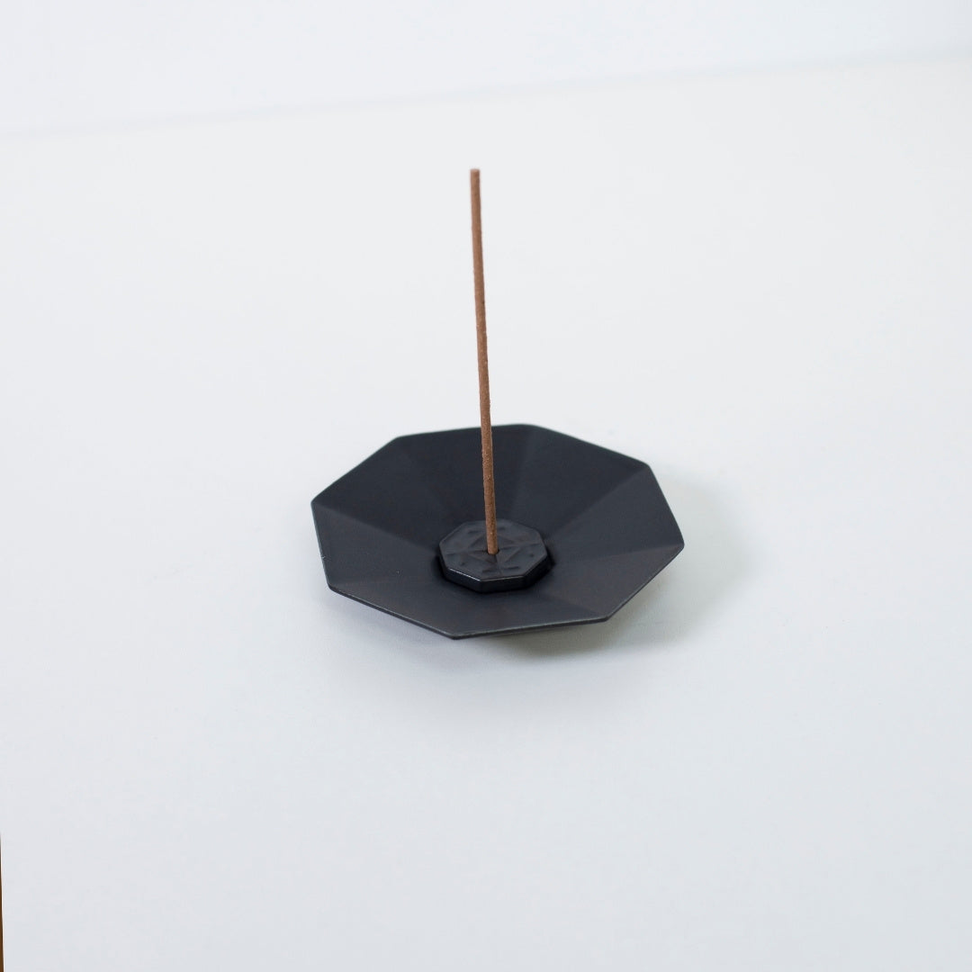 Top view of PORCELAIN INCENSE PLATE OCTAGON BLACK with incense stick - Japandi style incense holder with wabi-sabi