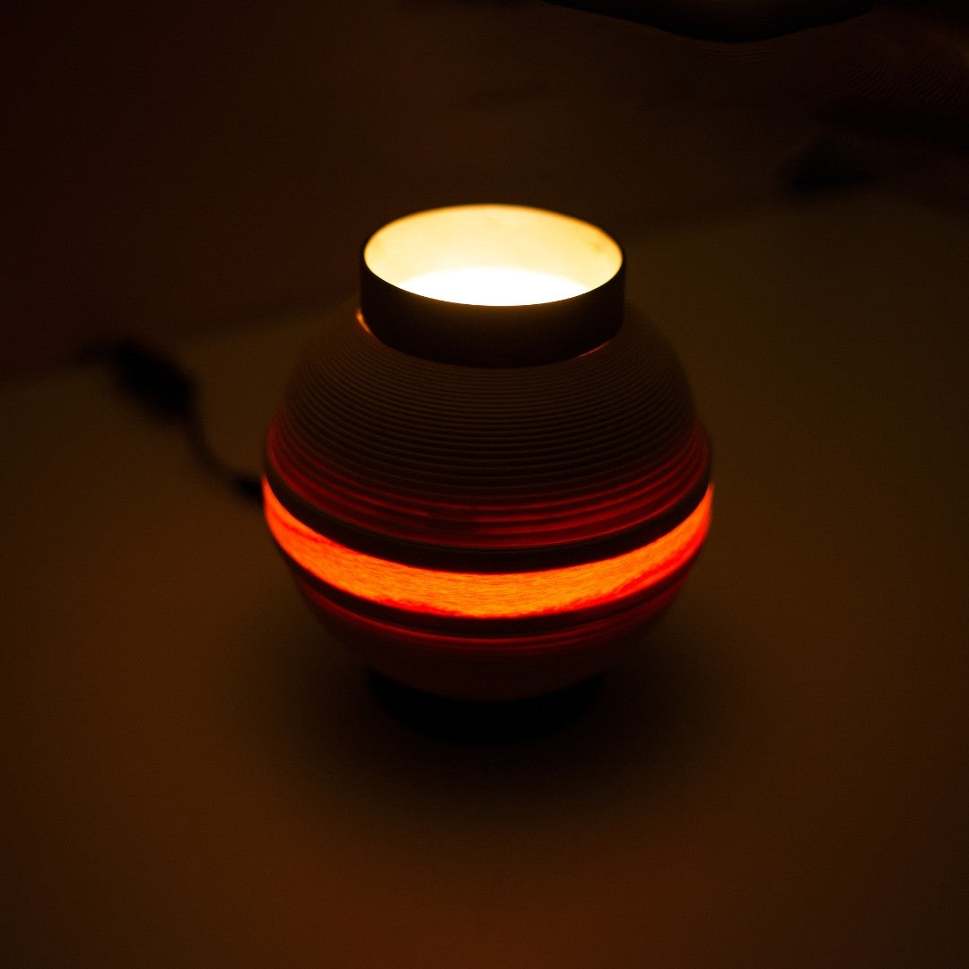 Top view of wood light lamp "Chochin 02" glowing softly, inspired by traditional round lanterns.