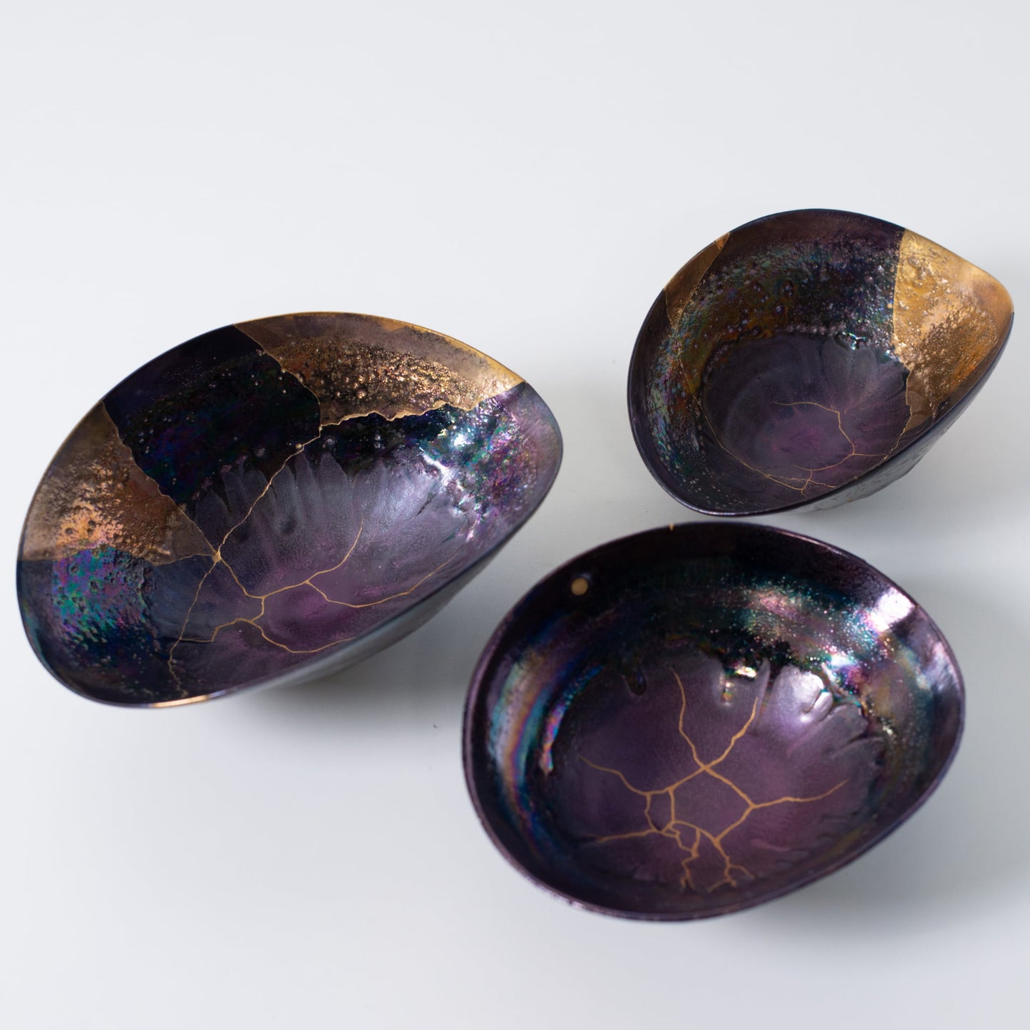 Three handcrafted Kintsugi bowls showcasing Japanese wabi-sabi pottery art