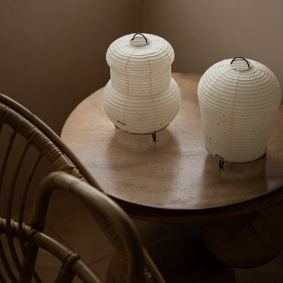 Two types of Japanese Paper Table Lamp "PAPERSON" on a wood table in Japandi style living room – Japandi bedside table lamps