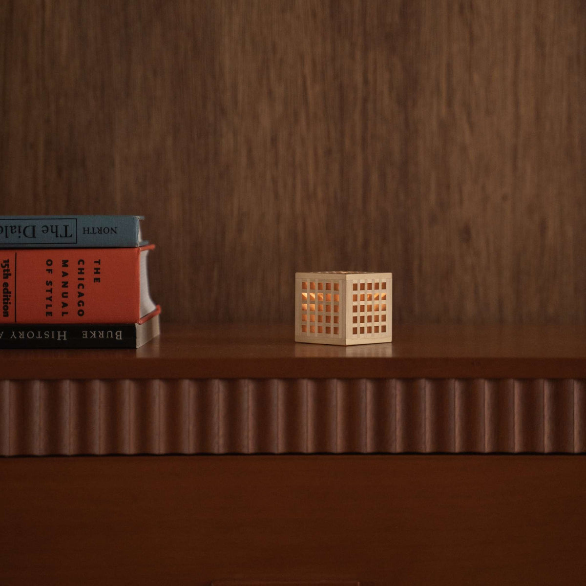 Lit Japanese Wood Mini Lamp "Hotaru" on a mid-century modern console table, glowing as a cozy Japanese table lamp.