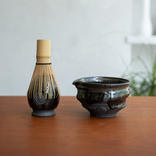 Dignity Blue spouted matcha bowl and Japanese matcha whisk stand on a wooden table to elevate your morning matcha ritual