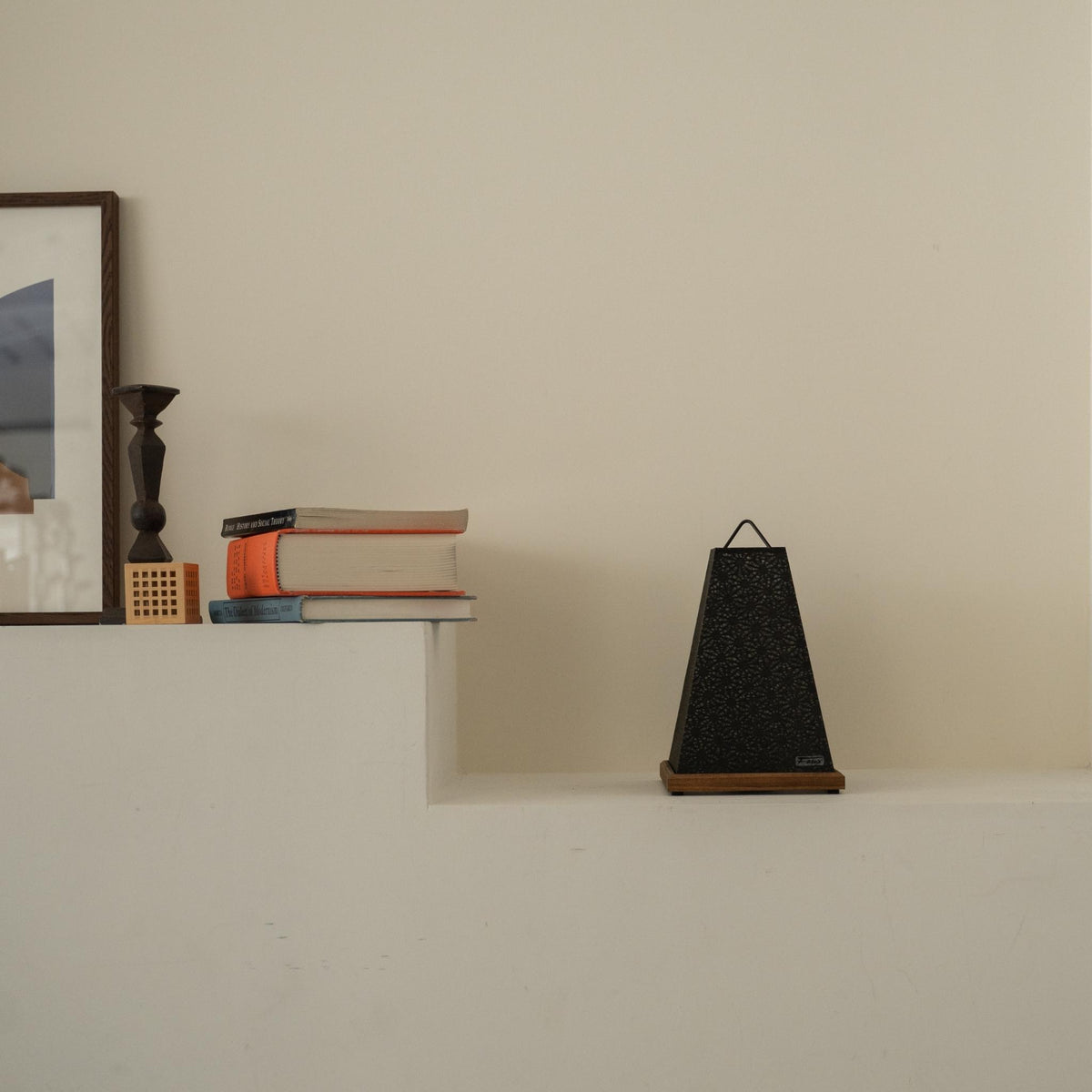 Unlit Japanese paper table lamp "Mini Akari" Black placed on a white console table in a minimalist Japandi living room.