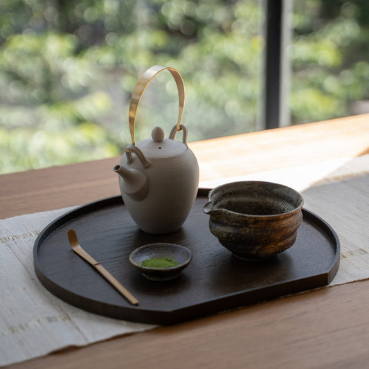 Rustic Sakigake Japanese matcha bowl with spout and a teapot on a tray, perfect for casual matcha latte making