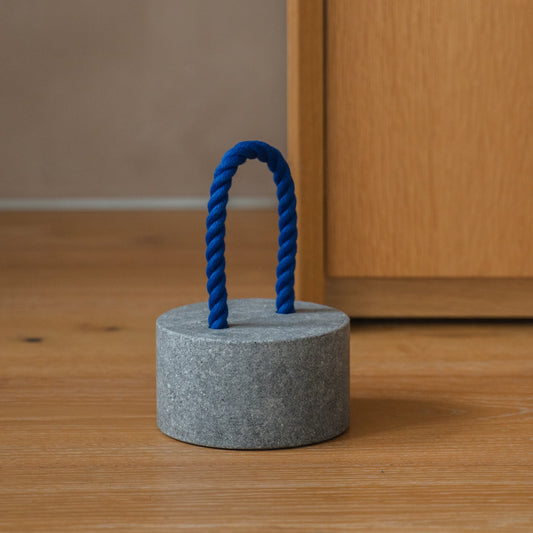 Japanese Aji Stone Doorstop "FUJ" in natural stone styled in a interior space, interior scene view.