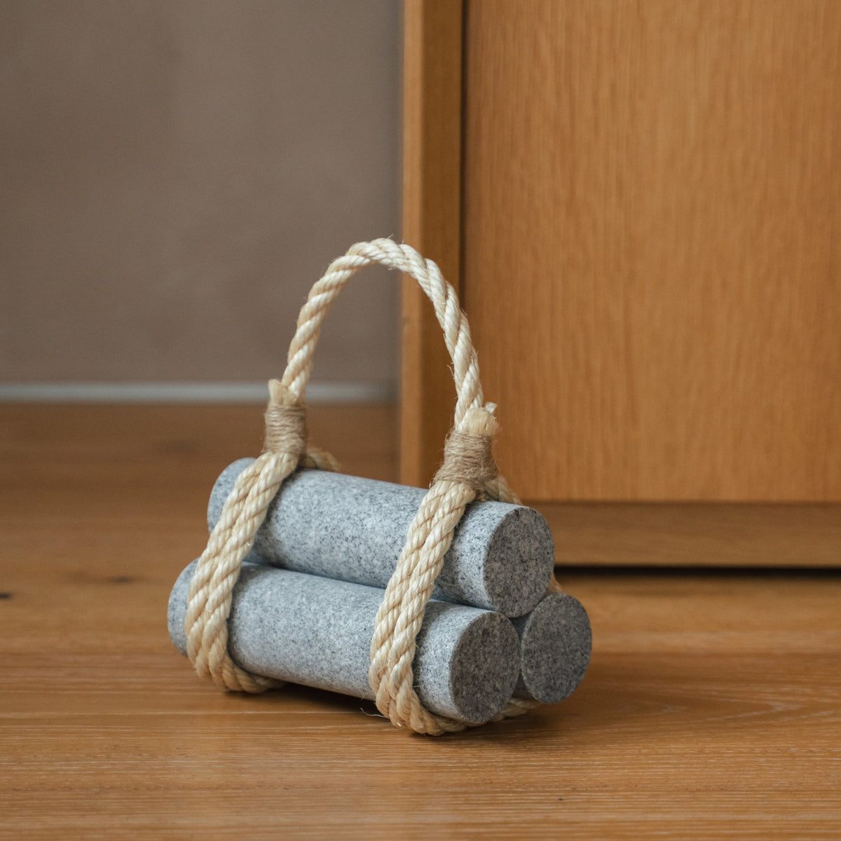Japanese Aji Stone Doorstop "komame" in natural stone styled in a interior space, interior scene view.