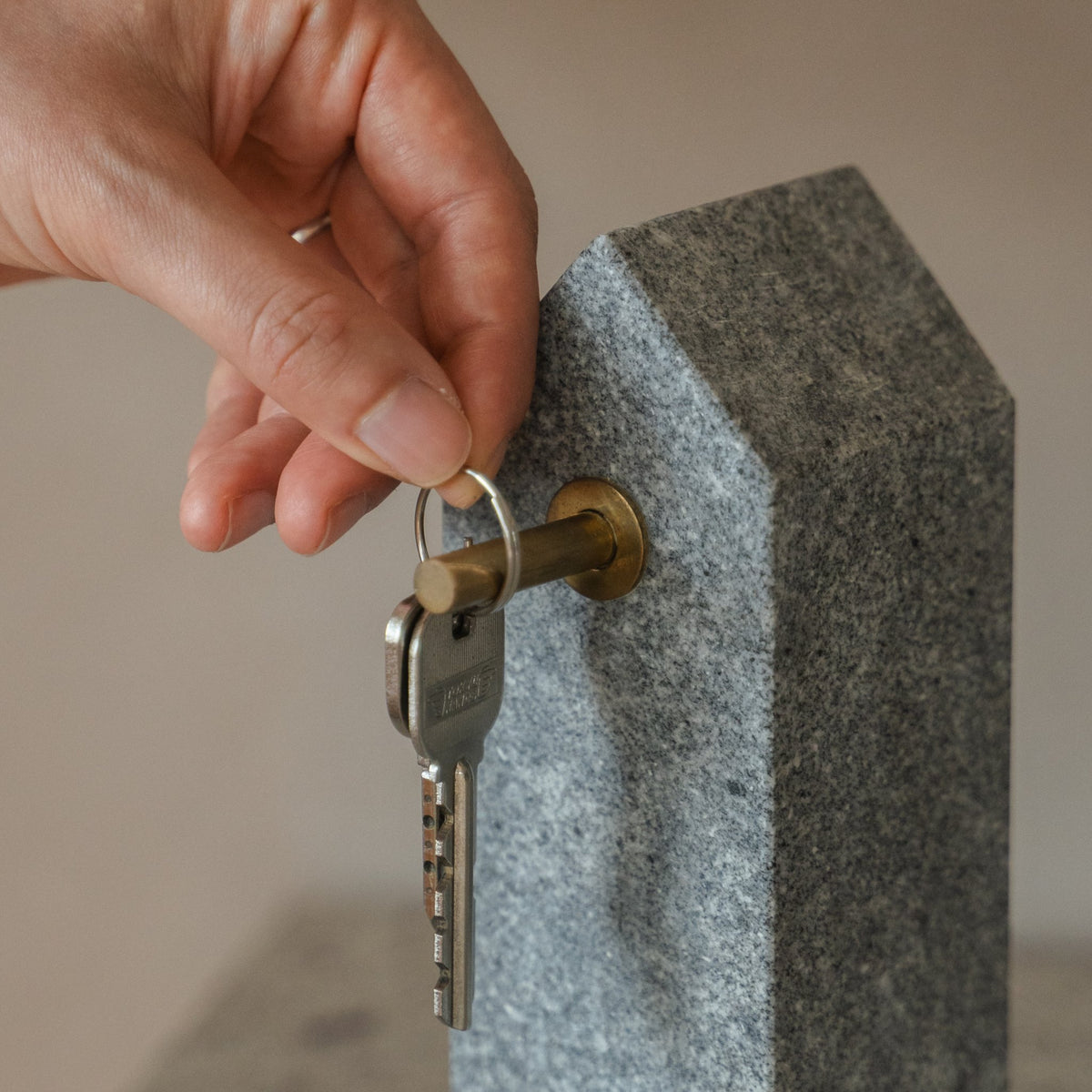 Japanese Aji Stone Key Holder in natural stone styled in a styled room, detail lifestyle view.