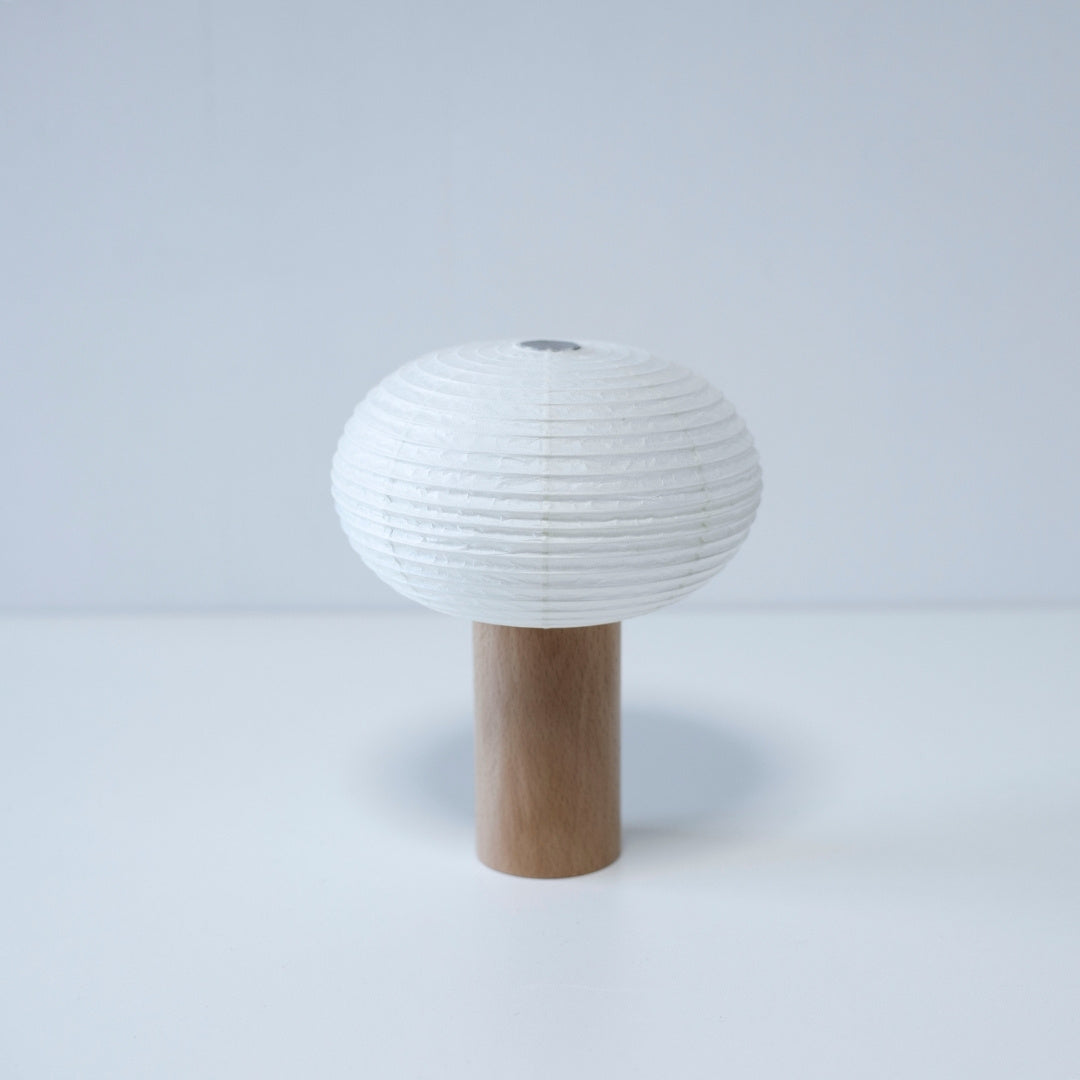 Paper table lamp "TORCHIN OVAL" with a wooden handle and white washi paper shade, handcrafted in Yame, Fukuoka, Japan, known for its traditional Yame lanterns.
