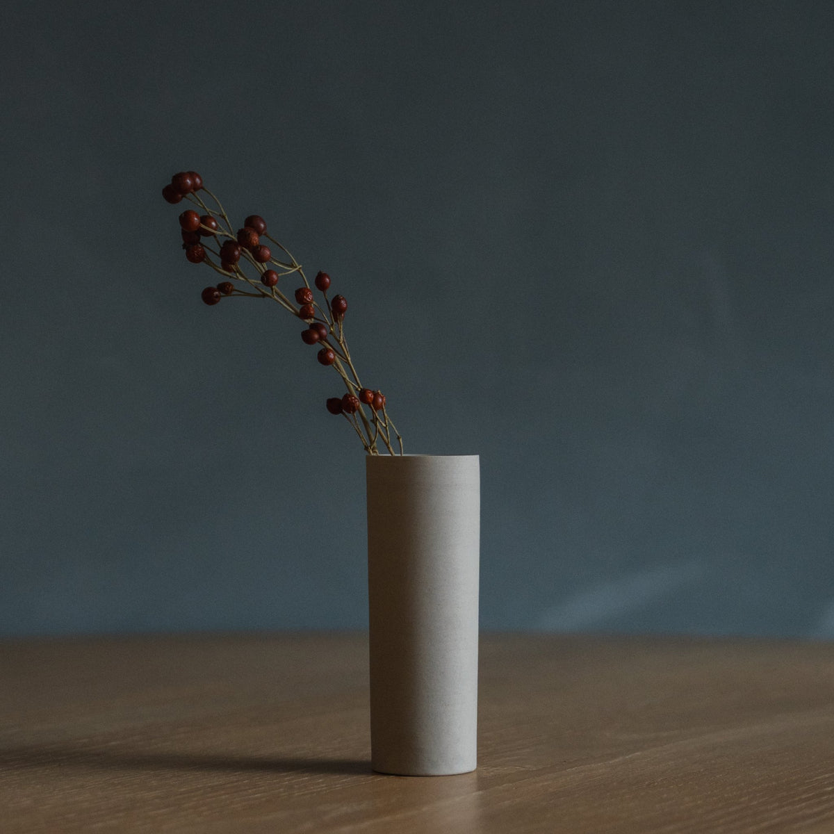 Japanese Single Flower Vase "Cylinder" in white styled in a dining room setting, dining scene view.