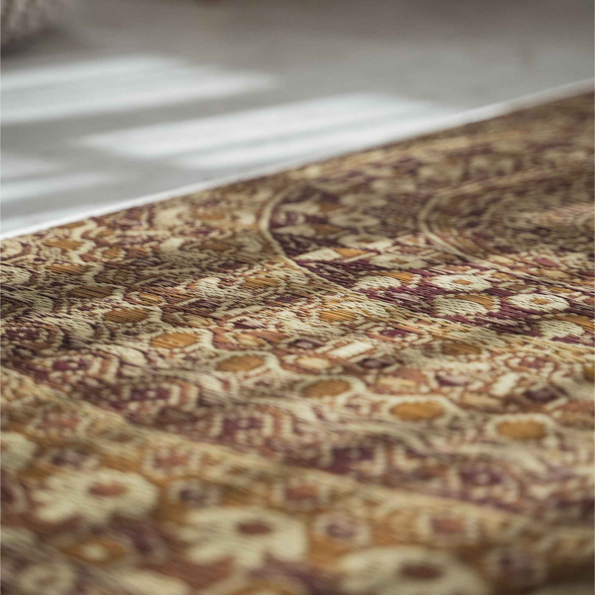Close up of the intricate brown mandala design woven into a rush grass tatami mat for meditation focus.