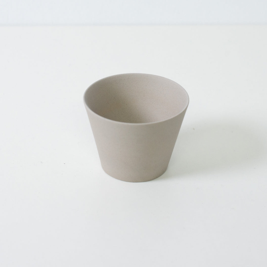 Angled top view of a matte white japanese tea cup showing the thin rim and conical geometry of the ensui design.