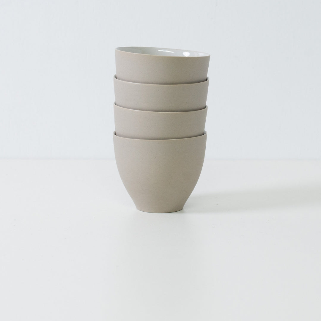 Four f shape japanese tea cups stacked vertically to demonstrate their storage efficiency and consistent modern design