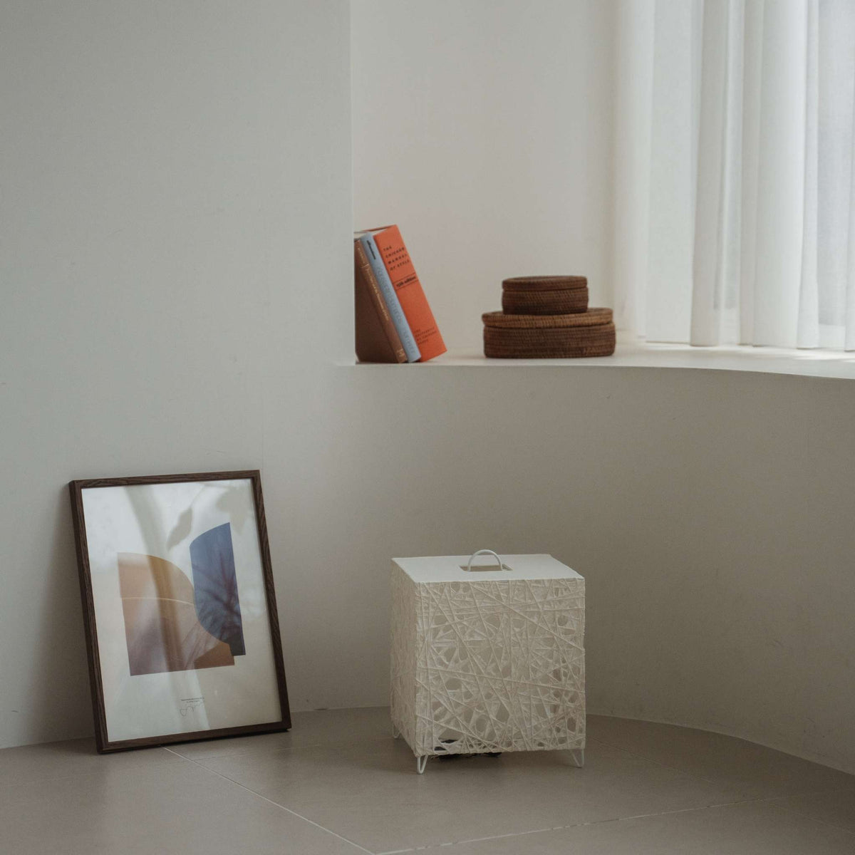 Modern black Japanese floor lamp Me-Look 03 white sitting unlit on a white tiled floor in a minimalist interior corner.