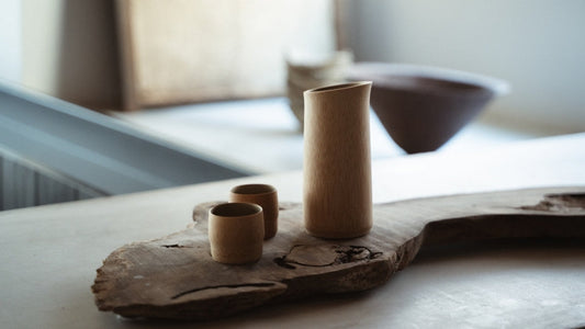 Japanese Bamboo Sake Set with beautiful Natural Bamboo color on a wooden plate in a Japandi room
