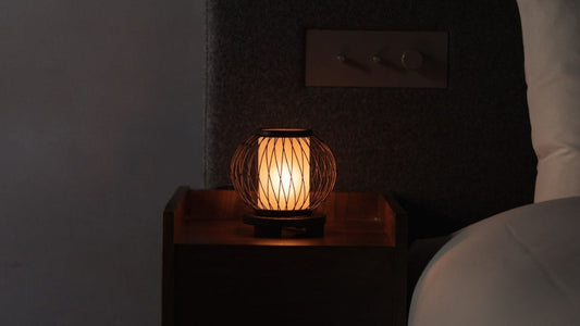 Japanese Bamboo Table Lamp "Moon Rabbit" emits warm glow on a bedside table in Japandi bedroom