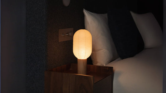 Japanese Paper Table Lamp "TORCHIN VERTICAL" emits warm glow into a Japandi bedroom