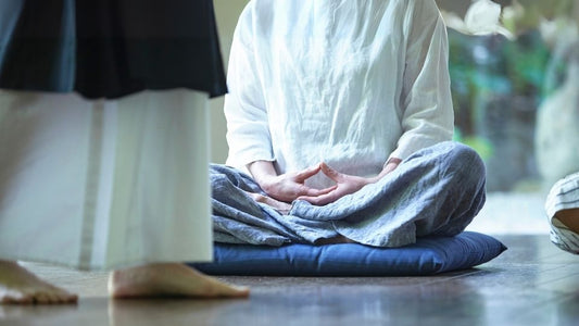 Practicing traditional zazen on a meditation cushion during a calm mindfulness session indoors