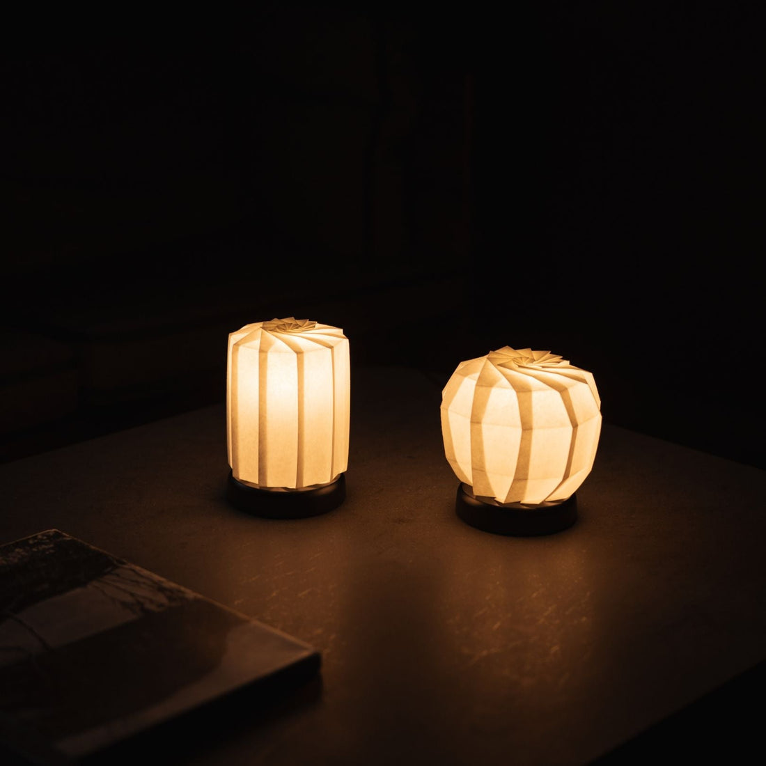 Two types of Japanese Origami Paper Table Lamp "Flower of Light" emit warm glow and calm atmosphere in the dark room
