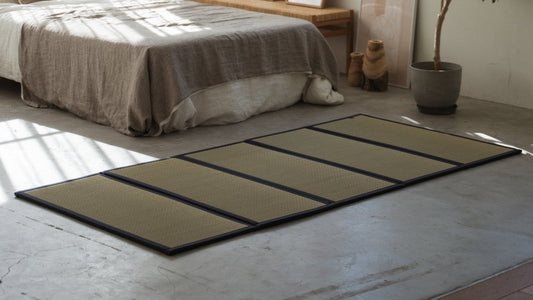 Five panel tatami mattress on a concrete bedroom floor serving as a breathable and healthy base for a futon.