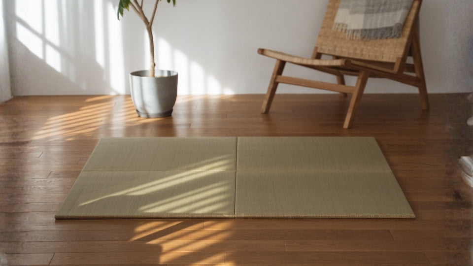 Four square tatami mat panels laid on a wooden living room floor creating a meditation room decor.