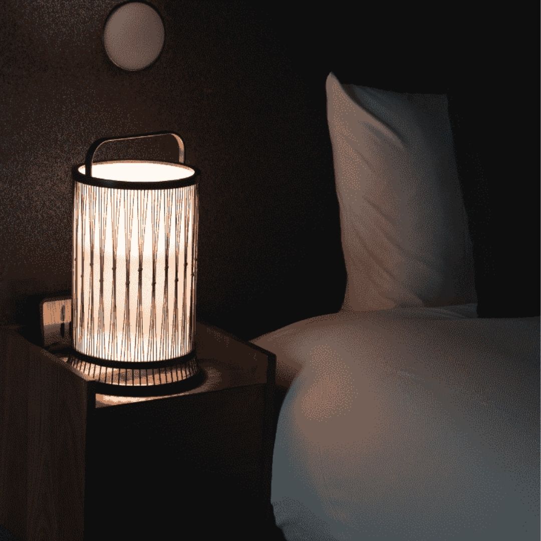 Japanese nightstand lamp on a bedside table in Japandi bedroom
