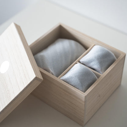 Gift set of iron-colored sake pitcher and two cups, crafted using traditional Japanese roof tile techniques, presented in a paulownia wood box.