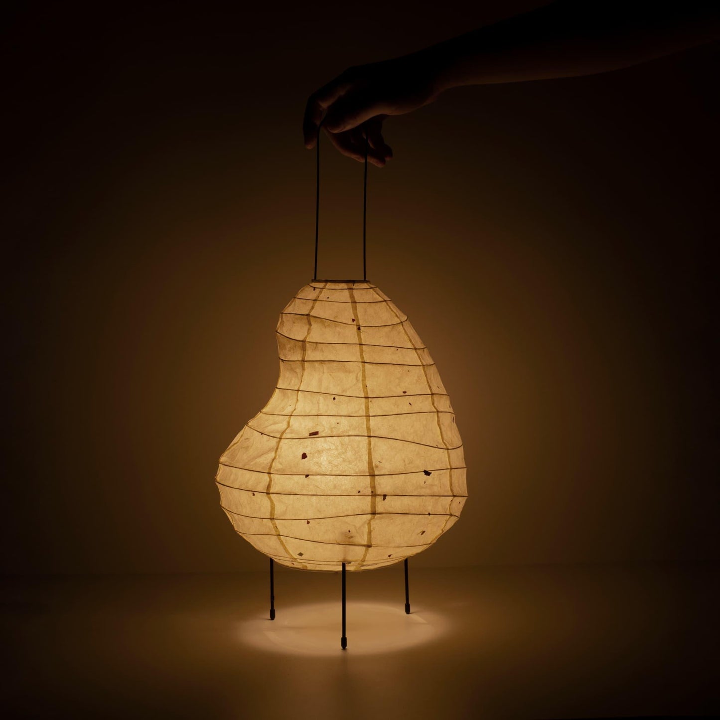 Handcrafted bean-shaped paper floor lamp showcasing Gifu lantern techniques and Mino washi paper.