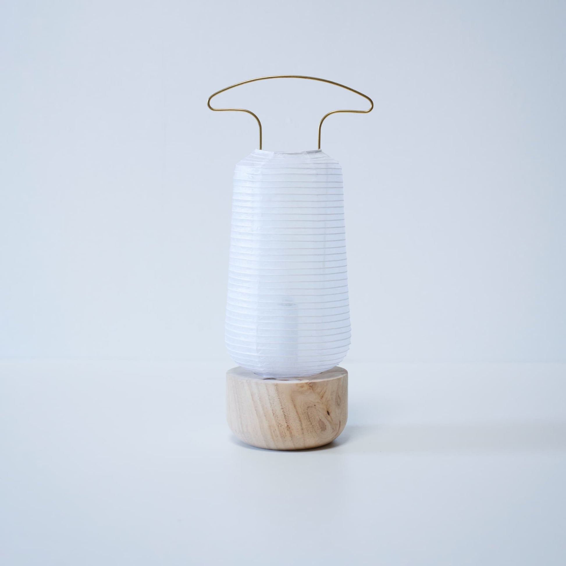 Traditional Japanese paper lantern placed against bright white wallpaper