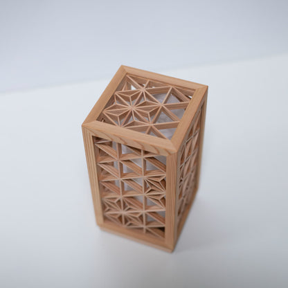 A table lamp using kumiko, a traditional Japanese technique of assembling small wooden pieces to create geometric patterns.