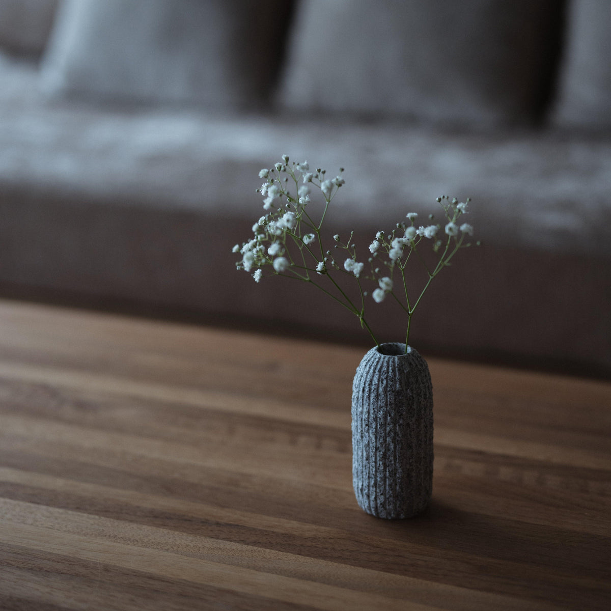 A small Awaji stone vase adds a touch of natural elegance to a minimalist Japanese-style living room.