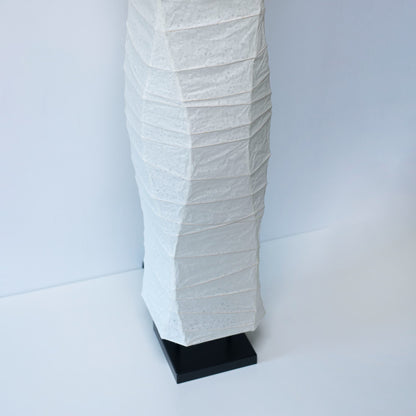 A close-up angled view of the lower part of a Japanese washi paper lamp, showing its smooth design on a white background