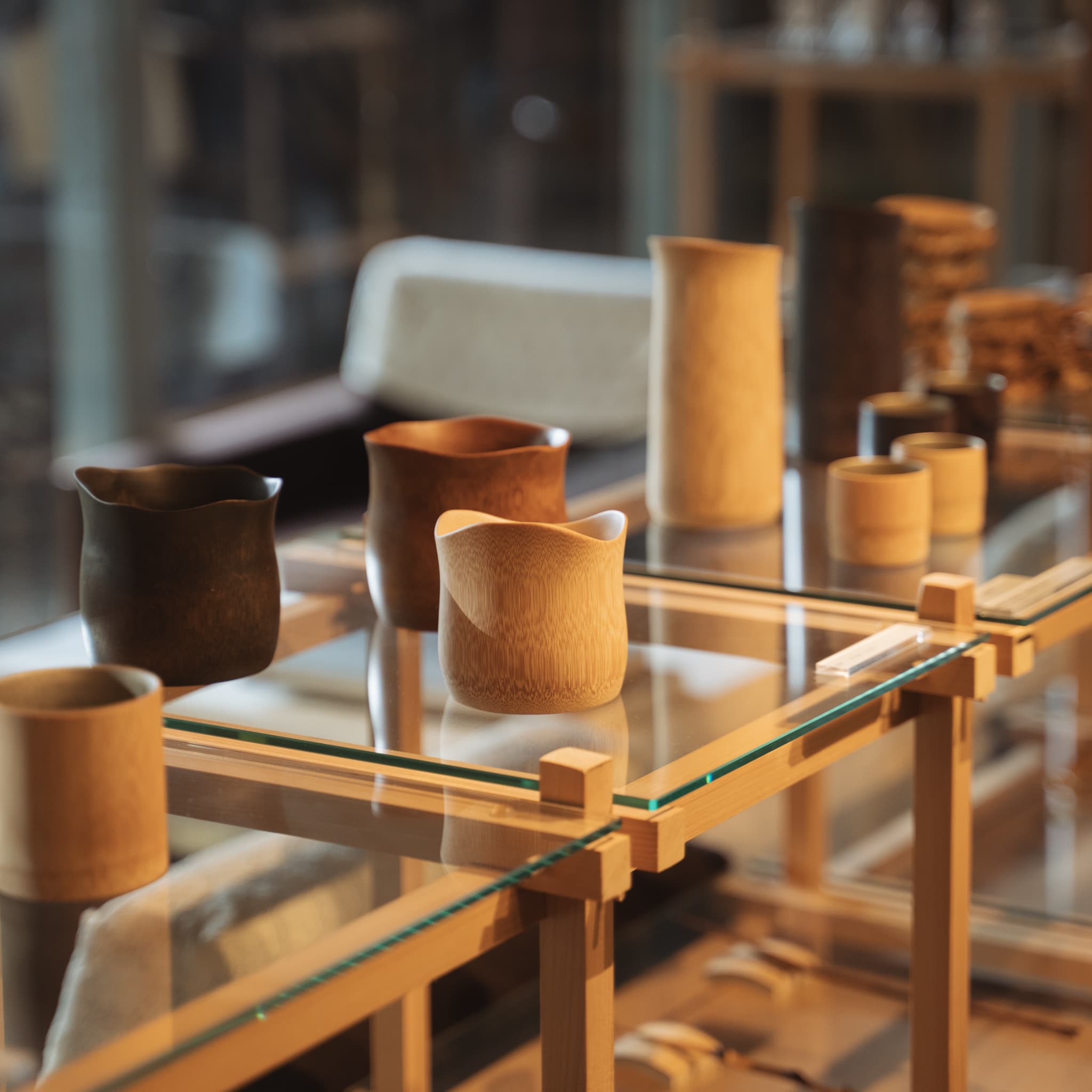 FInished bamboo cups displayed on a glass shelf