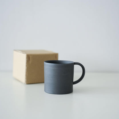 A simple black Banko ware mug in a minimalist paper box.