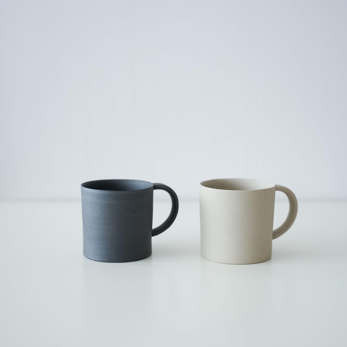 A set of simple black and white Banko ware mugs.