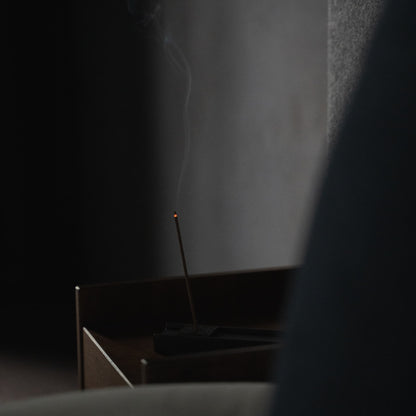 A Hinoki wood incense stick placed on a side table in a Japandi-style bedroom for ultimate relaxation.