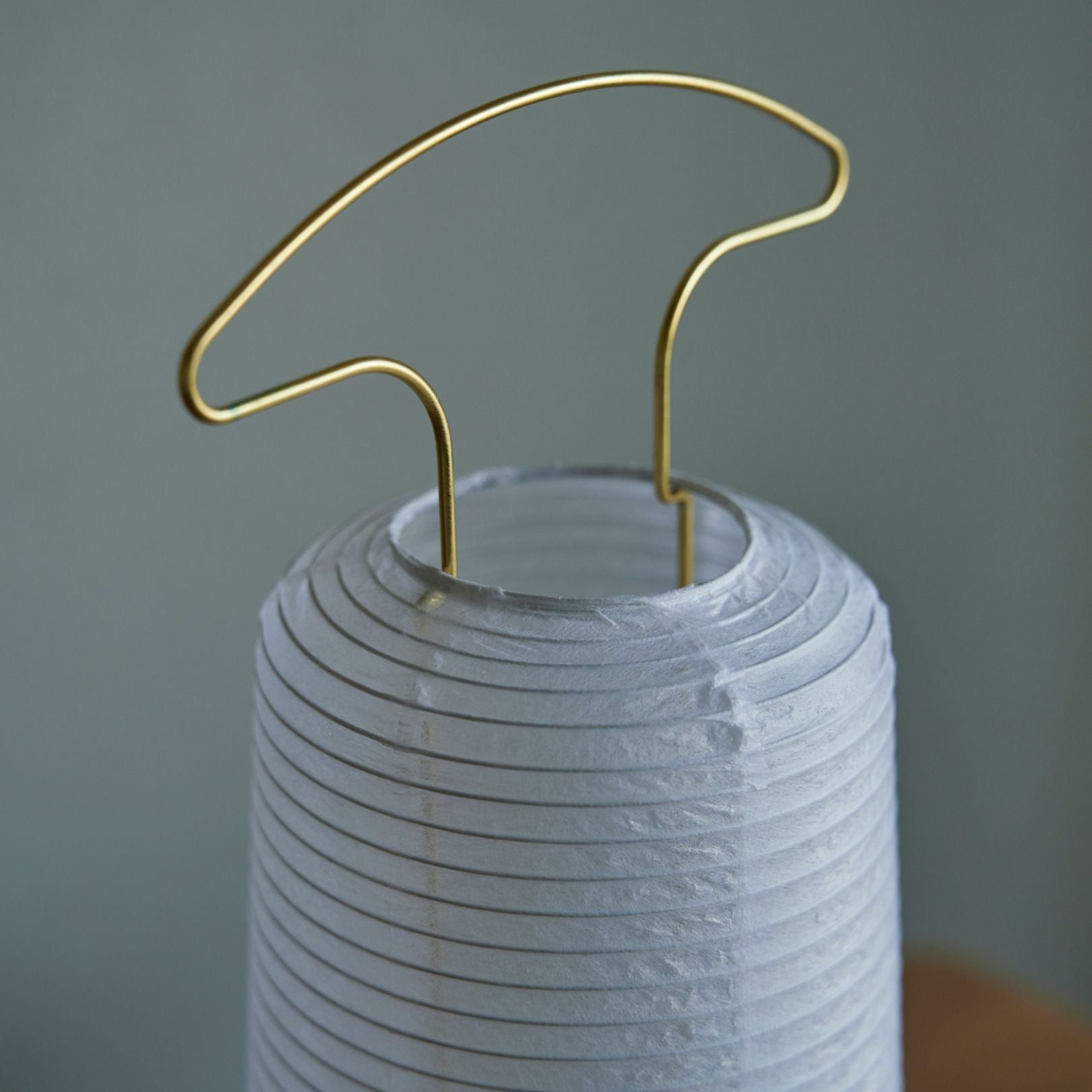 Close-up view of the handle on a traditional Japanese paper lantern from above