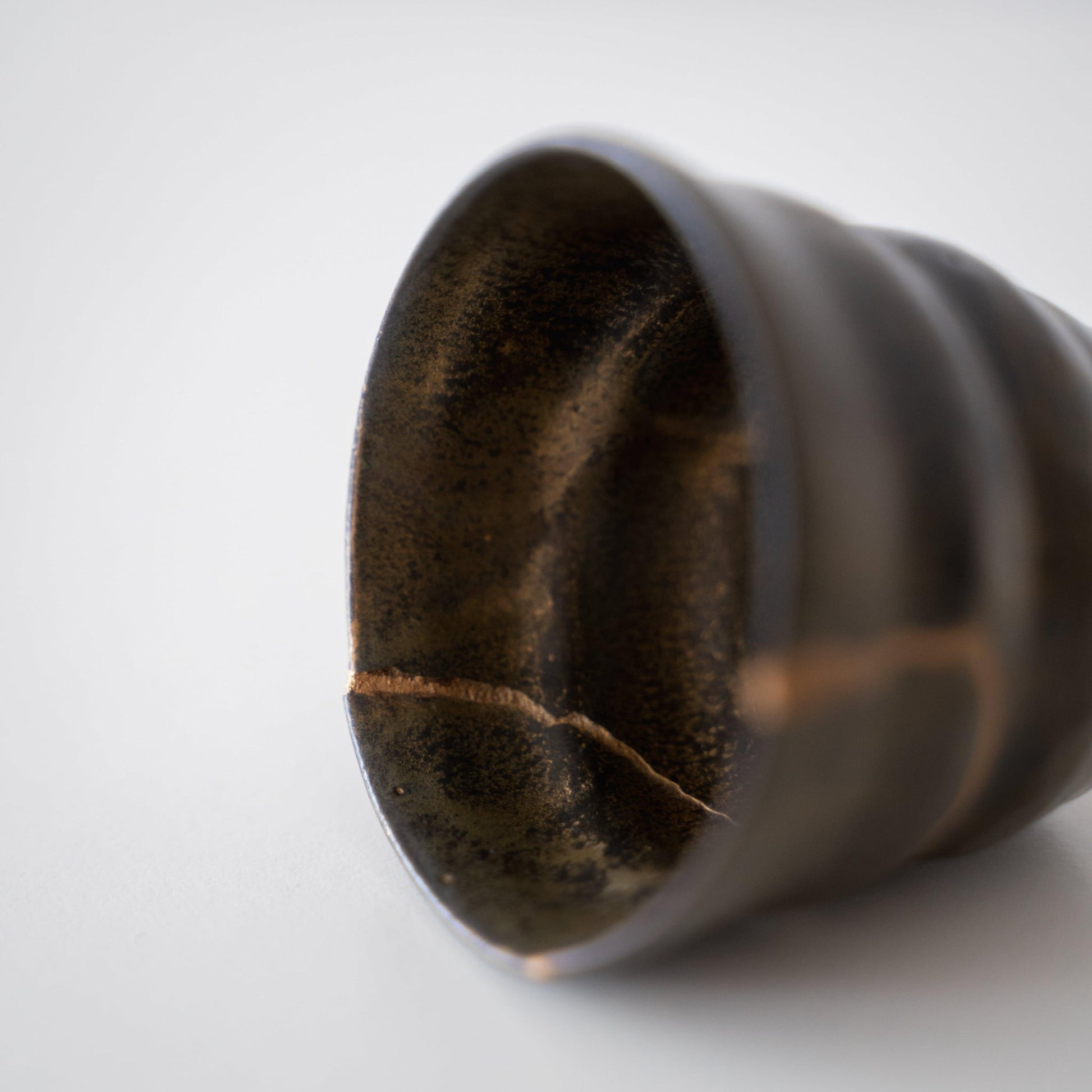 Close-up of Kintsugi repair on a Kintsugi Sake Cup "Thunder Moss"