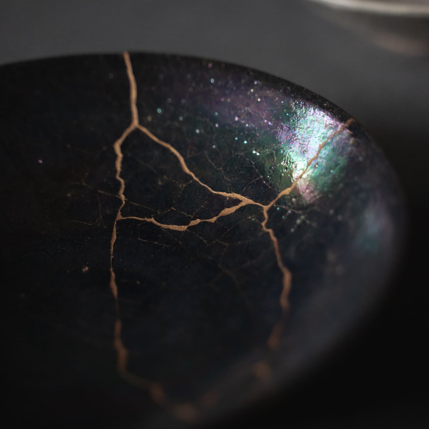 Elegant black kintsugi bowl with golden joinery